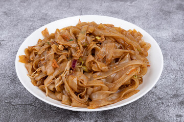 The fried rice noodles on the plate