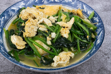 Spinach and scrambled eggs on the plate