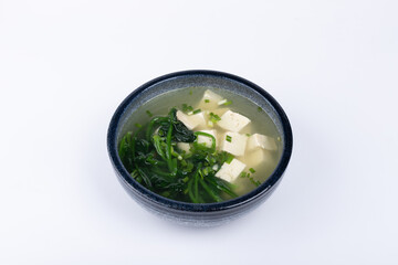 Spinach and tofu soup in a porcelain bowl