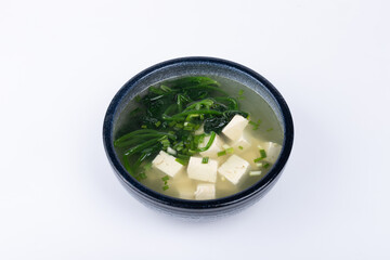 Spinach and tofu soup in a porcelain bowl