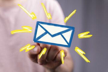Hand interacting with digital email icon, signifying new message alert.
