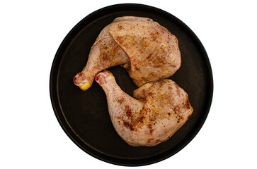 Raw Chicken Legs on a Black Plate