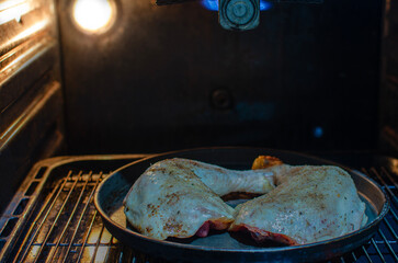 Roasting Chicken in Oven &ndash; Close-Up of Seasoned Meat Cooking