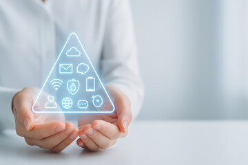 Email marketing funnel concept with digital icons glowing in triangle held by hands