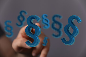 Abstract image of a hand interacting with 3D paragraph symbols.  Ideal for legal, law, or contract...