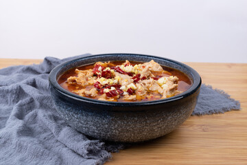 Sichuan-style boiled meat slices in a porcelain bowl