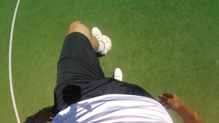 Individual in athletic wear skillfully dribbling a soccer ball on a vibrant green field, showcasing dynamic footwork and control while engaging in the sport, emphasizing movement and technique - Powered by Adobe