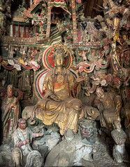Clay sculpture of Buddha at historical Guanyin Hall in Liangjiazhuang Village, Changzhi, Shanxi, China, known for extraordinary Ming Dynasty suspended sculptures. National heritage.