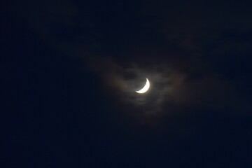 half moon covering by cloud floating on sky in night background