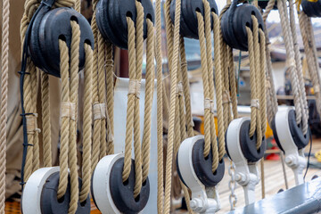 Selective focus of a boat poulie with rope lines, Vintage pulley (Katrol) block for Sail, A wheel...