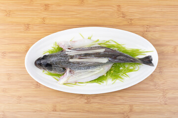 Steamed sea bass in a steaming pot