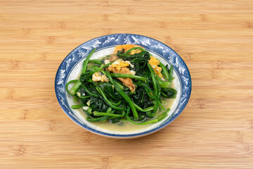 Spinach and scrambled eggs on the plate