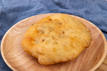 The fried food, scallion meat Patty, on a wooden plate