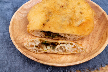 The fried food, scallion meat Patty, on a wooden plate