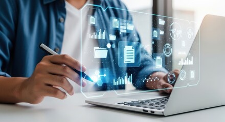 A person uses a pen to interact with a digital interface displaying data and charts on a laptop