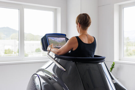 Woman Training in Vacuum Infrared Fitness Capsule