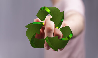 Hand touching a 3D recycle symbol. Eco-friendly concept. Sustainability.