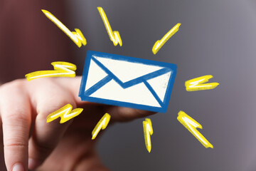 Bright, bold email icon on finger.  Digital communication concept.