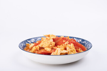 The scrambled eggs with tomatoes on the plate