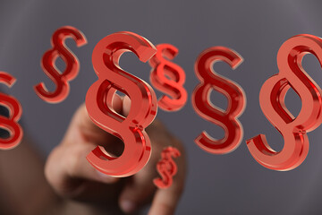 Abstract image of red paragraph symbols floating, ideal for legal or law concepts.