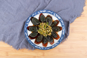 The cold mixed preserved eggs with pine flowers on the plate