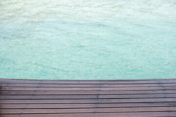 Wooden deck overlooking calm turquoise water for relaxation and leisure