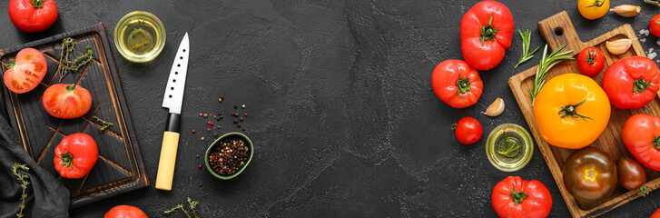 Composition with ripe tomatoes on dark background with space for text