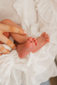 newborn baby feet in mothers hands