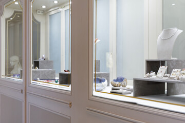 Showcase of exquisite jewelry and gemstones in an upscale retail setting. High-end display cases and sophisticated ambiance.