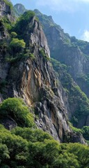 Obraz premium Steep mountain face with lush greenery