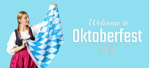 Happy woman with Bavarian flag on blue background. Octoberfest celebration