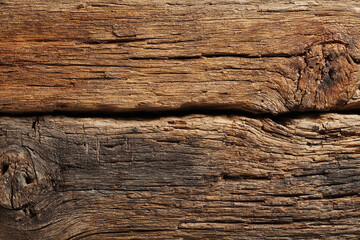 Naklejka premium Rustic weathered wood planks showing grain texture and knots
