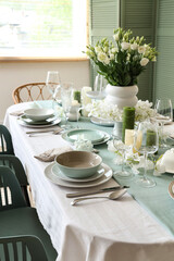 Beautiful table setting with white flowers for wedding celebration in room