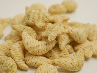 Crunchy salty snacks on white background