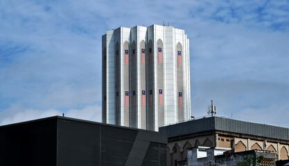 modern office  building with national flags in blue sky
