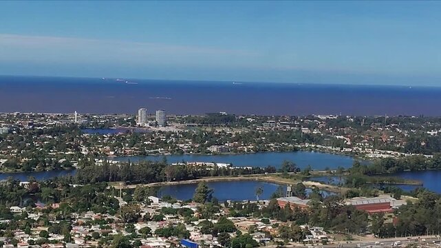 Sweeping aerial landscape video of high class district at canelones department, captured from the passenger window of an airplane. 