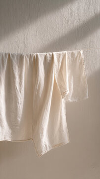 Soft fabric hanging in minimalistic laundry room with gentle light