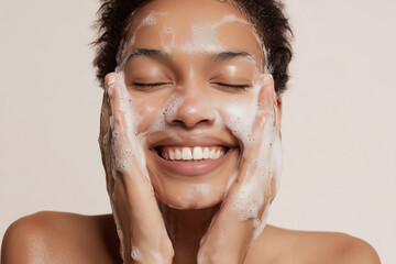 Smiling woman washing face with foaming cleanser, clear skin, joyful expression, skincare routine