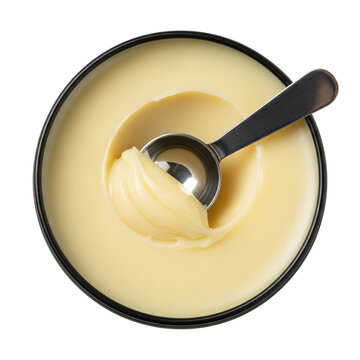 Yellow cosmetic balm or ghee in black bowl