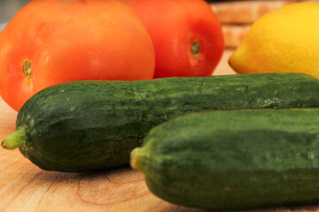 Whole Lemons, Cucumber, and Tomato on Wooden Cutting Board, Colorful Display
