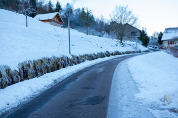 quiet, snow-covered road winds winter landscape, pavement after heavy snowfall, Slippery surface...