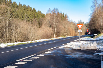quiet, snow-covered road winds winter landscape, pavement after heavy snowfall, Slippery surface...