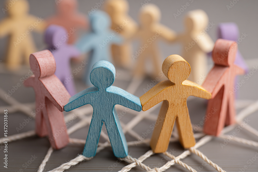 Poster colorful wooden figures holding hands forming a circle connected by string a concept of teamwork and