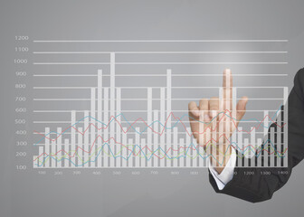 Business hand touching growth graphs of financial indicator and accounting market economy analysis chart, business strategy concept.