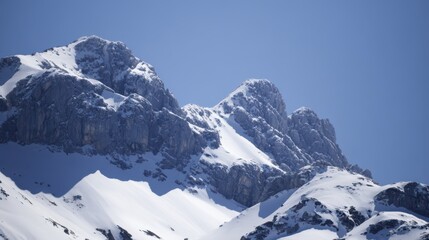 Obraz premium Majestic Snow-Capped Mountains Under Clear Blue Sky in Winter