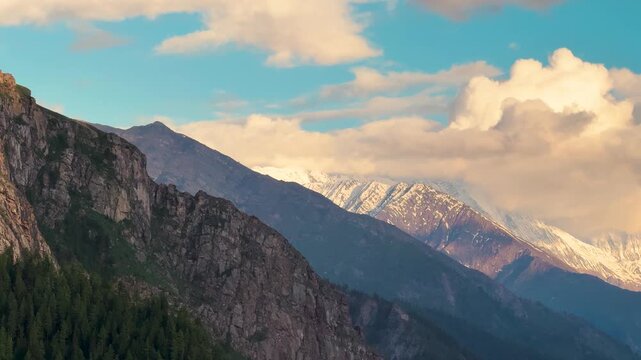 4K shot of Orange clouds above the Himalayan mountain range during the sunset after rain in monsoon season as seen from Killar town in Chamba district, Himachal Pradesh, India. Scenic sunset.