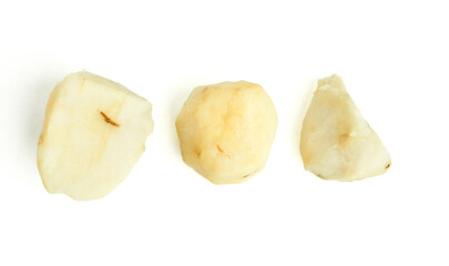 Peeled potato chunks arranged in a row suggesting preparation steps  isolated on white background
