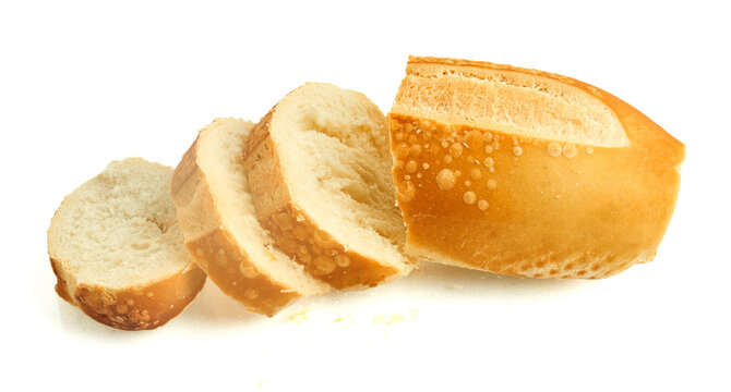 Cut bread roll with even slices prepared for plating or toasting isolated on white background
