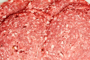 Close view of salami texture revealing marbled pattern and the concept of flavor through curing and...