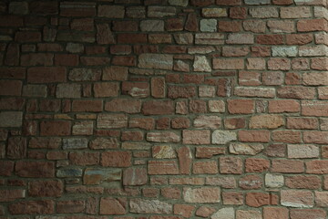 Fototapeta premium Textured sandstone brick masonry wall surface